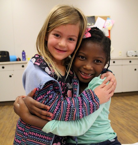 A picture of two young girls hugging