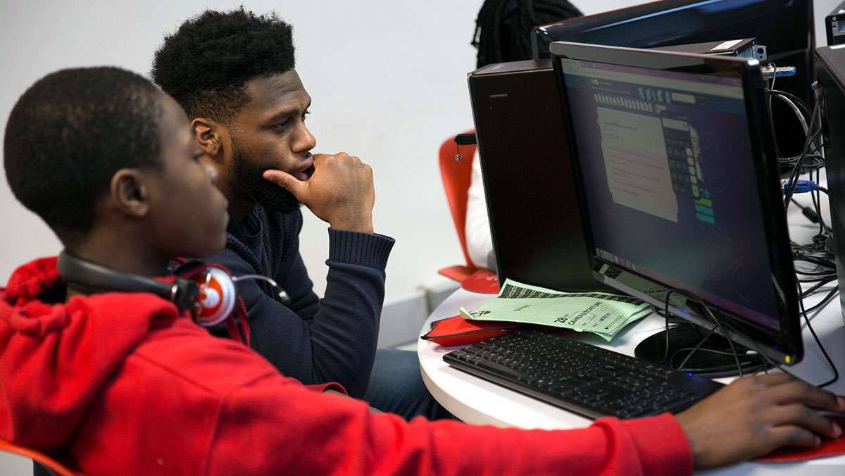 Two youth working together on a computer