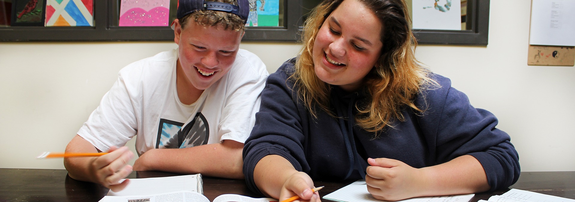 Two teens working on their homework