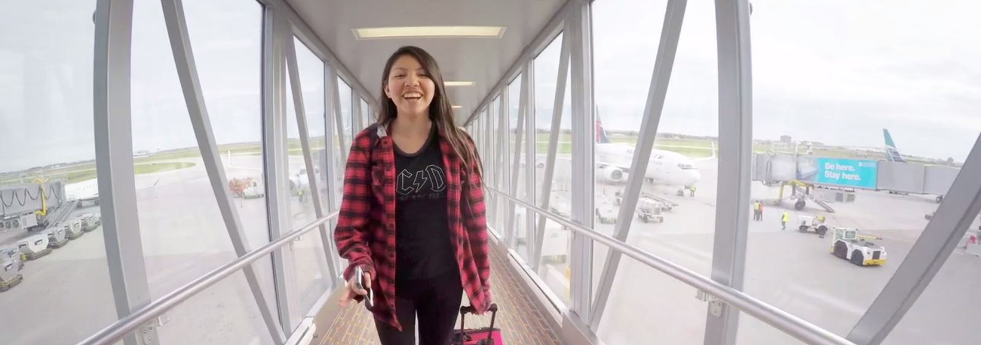 Boys and Girls Club youth named Legacy walking off an airplane.
